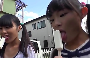 Tiny japanese schoolgirl weathering ice cream
